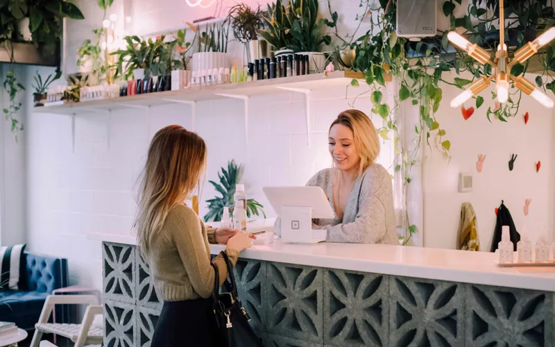 A customer at the counter of a small flower shop